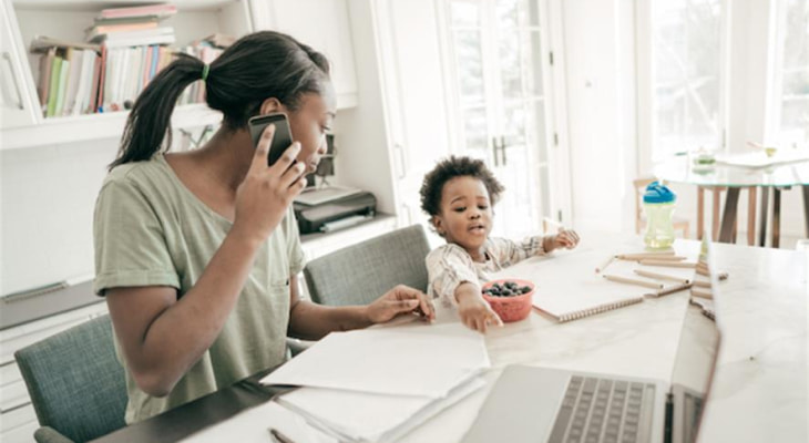 Young mom with son and paperwork on phone