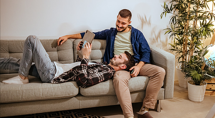 Two guys sitting on the couch planning