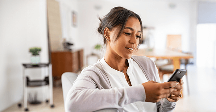 woman smiling at cellphone