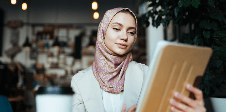 Woman uses tablet to check investments