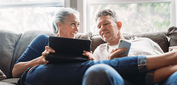 Mature couple relaxing with tablet