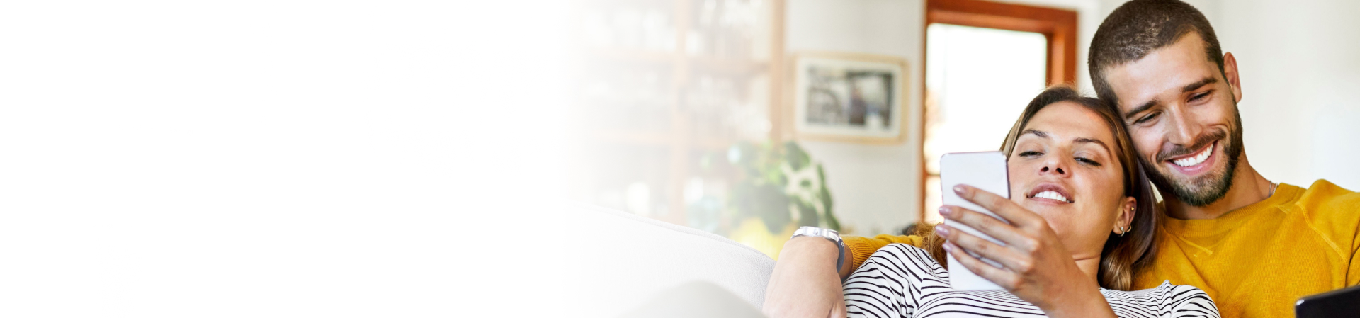 Couple sitting together looking at their cell phones